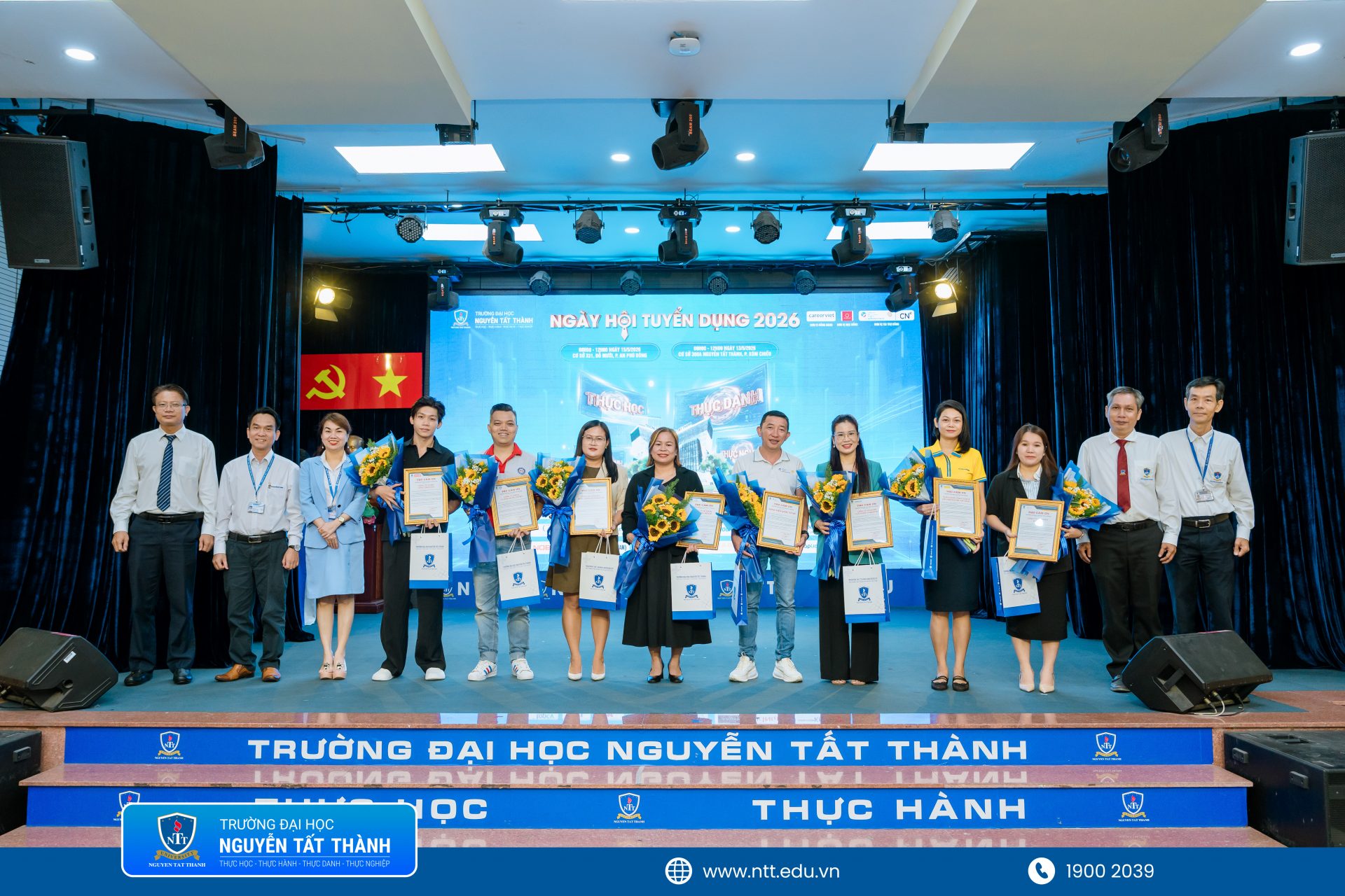 Đại diện Trường Đại học Nguyễn Tất Thành trao hoa và quà lưu niệm tri ân các doanh nghiệp, nhà tuyển dụng đồng hành cùng Ngày hội Tuyển dụng tháng 5/2026.